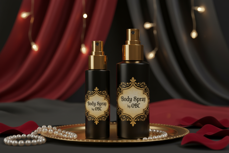1oz and 2oz black bottle with a gold spray top elaborately labeled body spray by OBC with sexy elaborate background