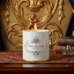 16 ounce white tin candle with open flame labeled elaborately divine by OBC with a elaborate background