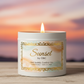 16oz white tin candle with open flame elaborately labeled sunset by obc with a nice background