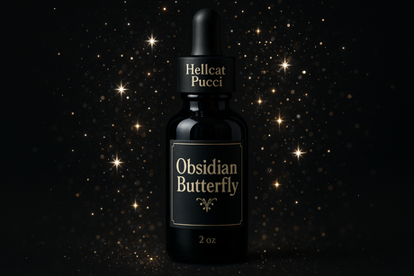 Show me a a circular dropper bottle 2 ounces with Hellcat Pucci on the dropper and labeled obsidian butterfly have the bottle surrounded by sparkles